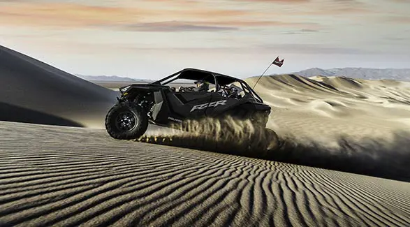 side profile of a polaris rzr pro xp 4 side by side in the dunes