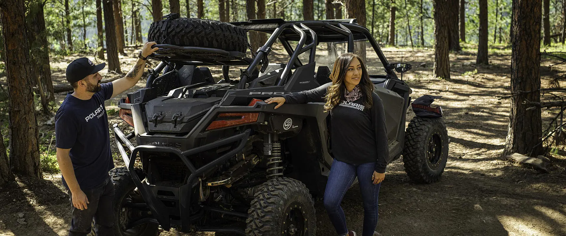 people hanging out after a ride in their polaris rzr pro xp side by side