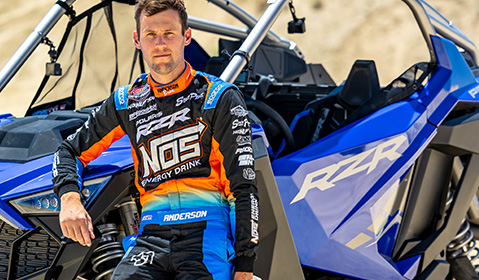 RJ Anderson in front of an RZR R Polaris blue