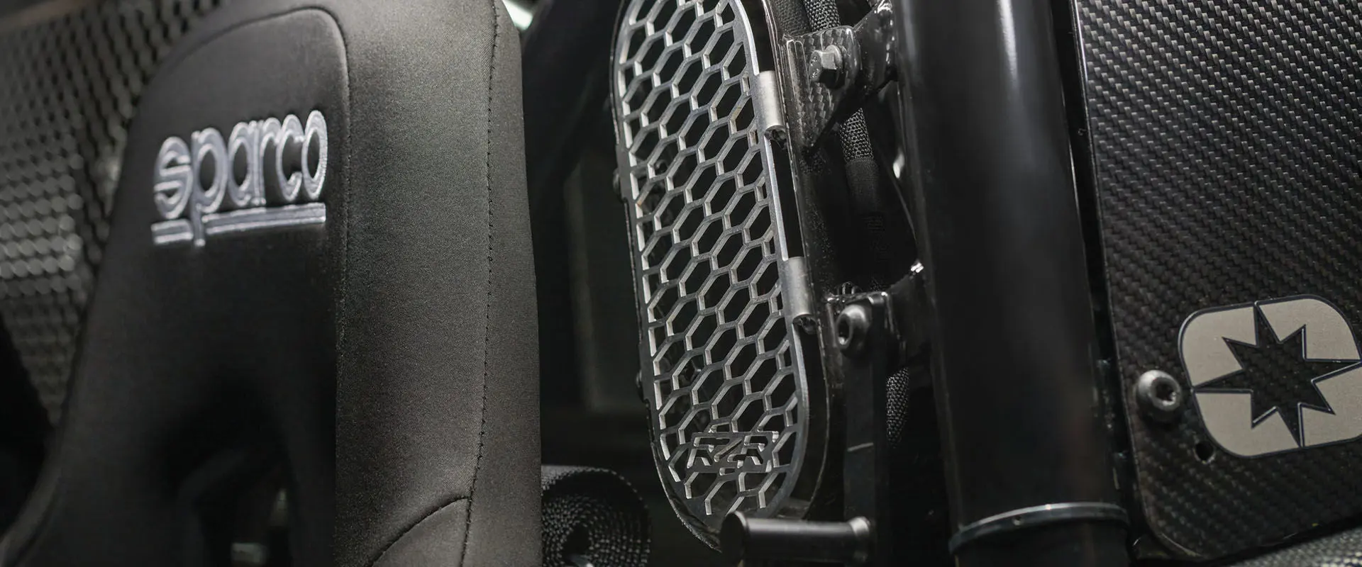 Close-up of the top of the Polaris RZR Pro R Factory Edition seat highlighting the SPARCO branding on it and the ventilation slot on the side.