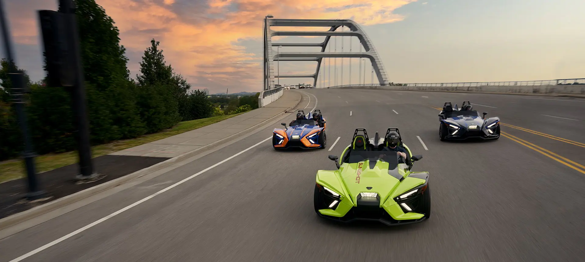 Three Slingshot vehicles riding on the road