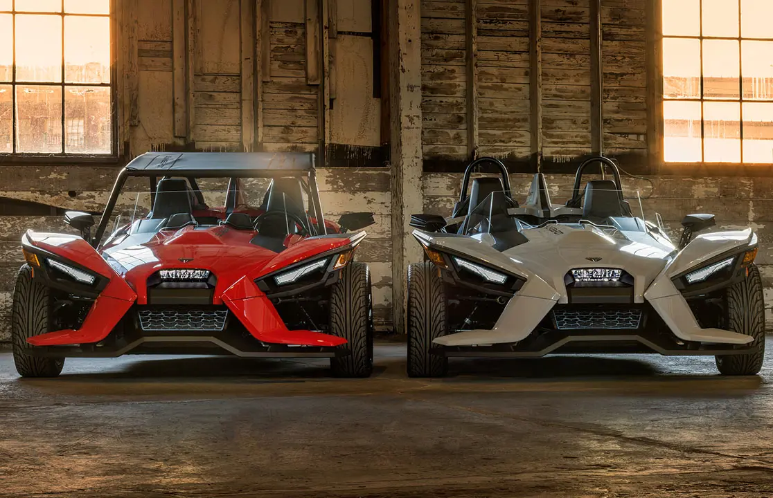 front view of two polaris slingshot's parked in a garage