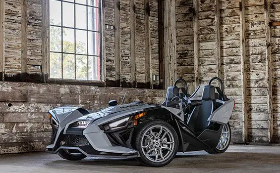 front/side view of a polaris slingshot SL three-wheeled motorcycle parked in a garage