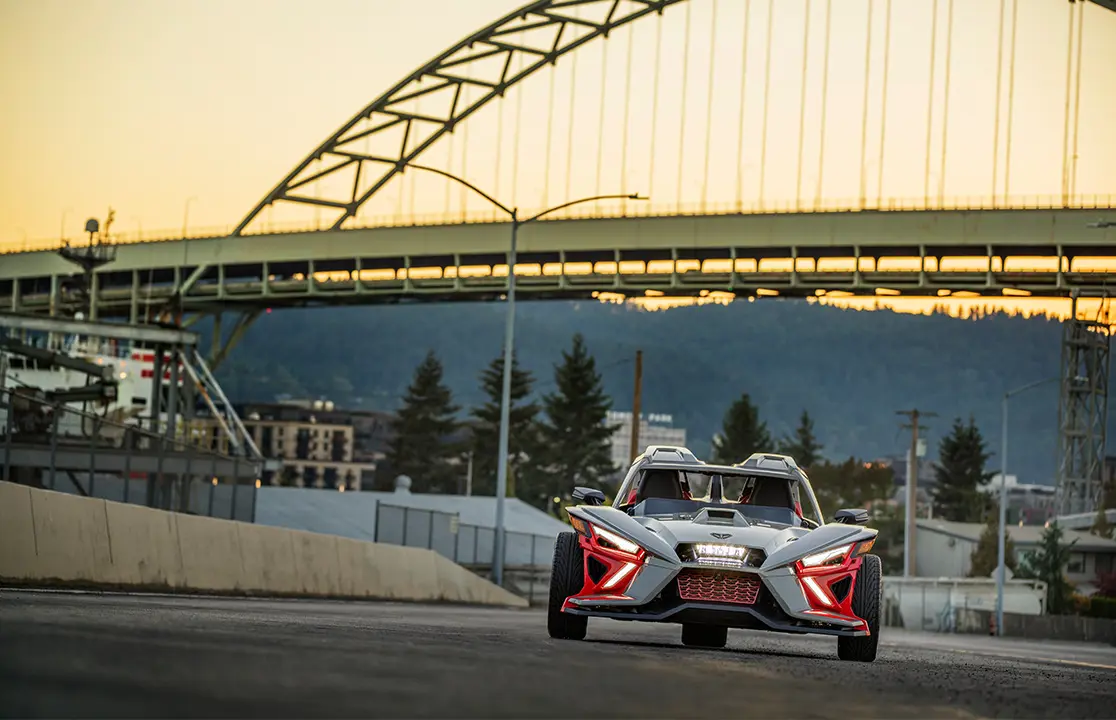 front end with illuminated headlights of a polaris slingshot slr three-wheeled motorcycle