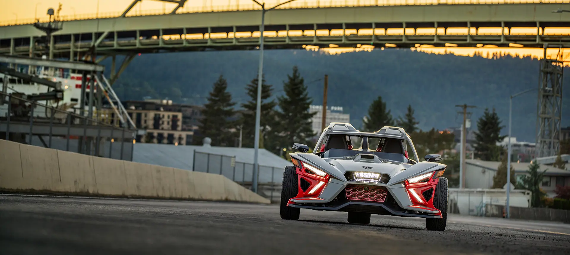 front end with illuminated headlights of a polaris slingshot slr three-wheeled motorcycle
