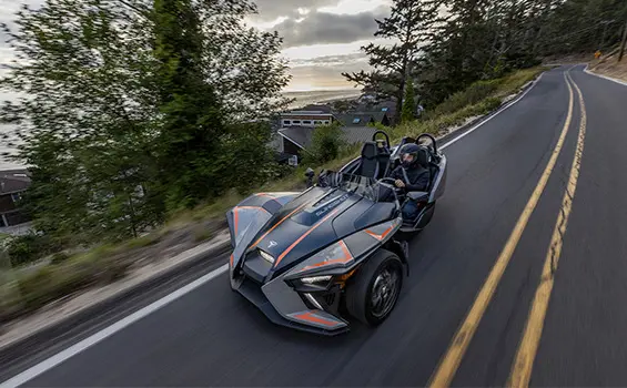 polaris slingshot slr three-wheeled roadster cruising on a highway