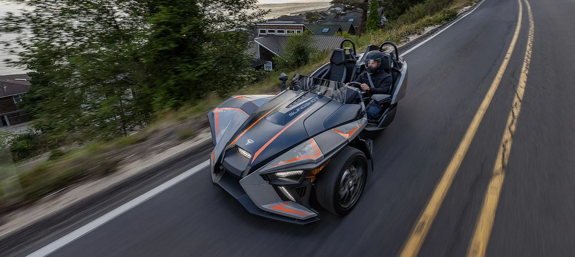 polaris slingshot slr three-wheeled roadster cruising on a highway
