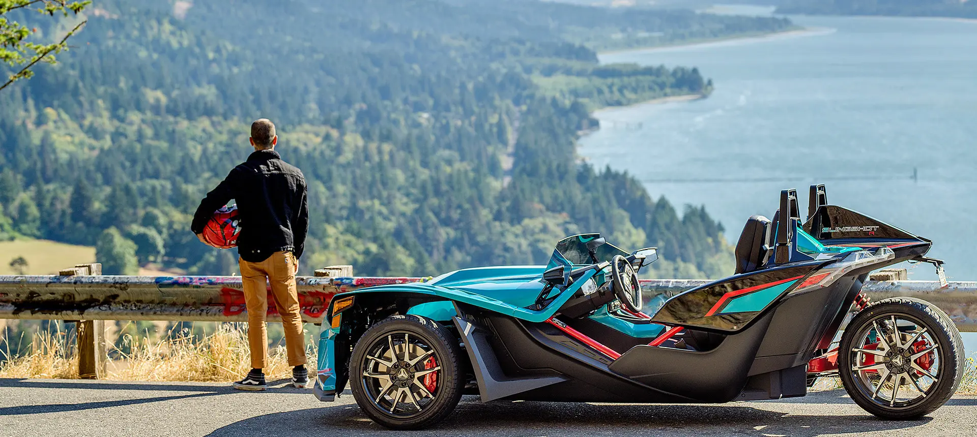 Man and woman getting on a Polaris Slingshot