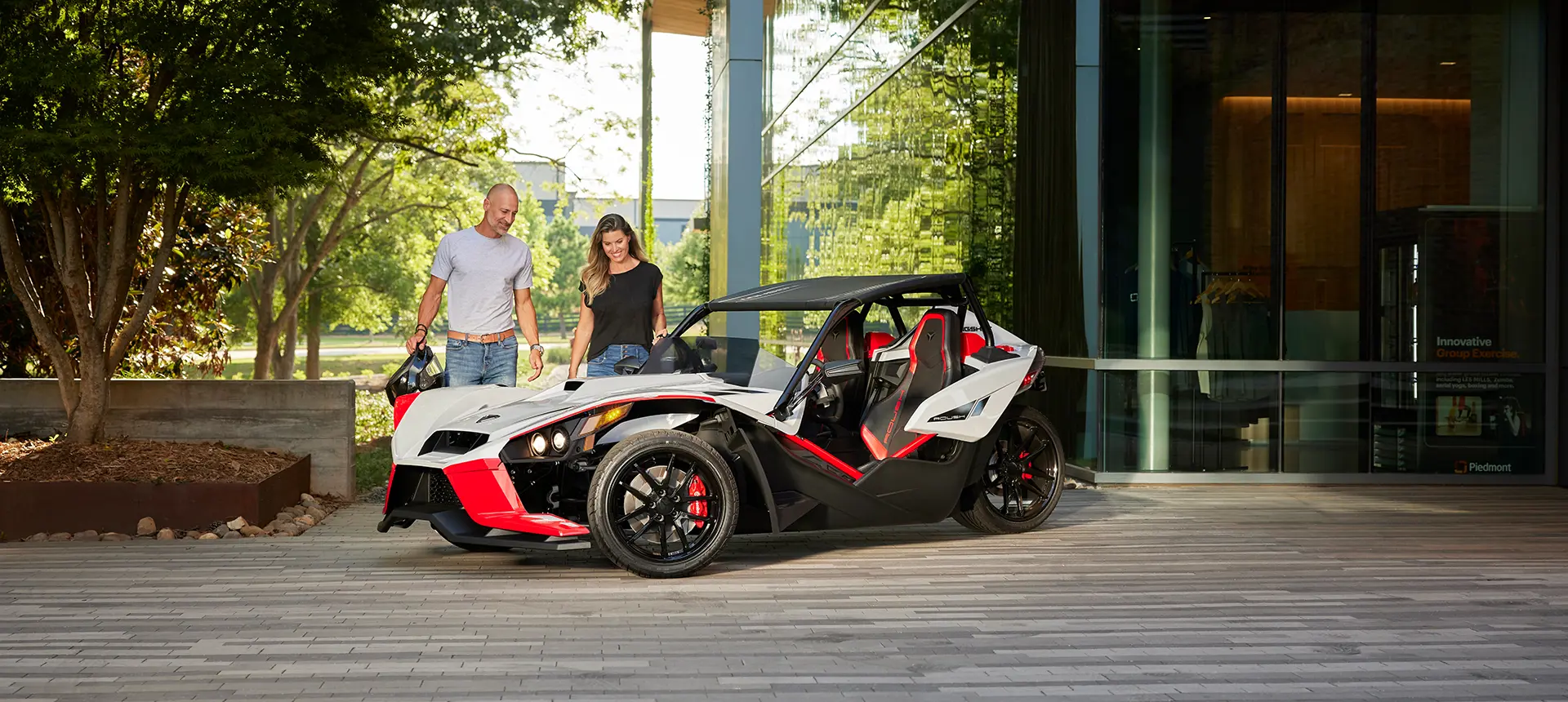 people walking towards a 2024 polaris slingshot ROUSH® edition roadster