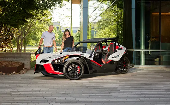 people walking towards a 2024 polaris slingshot ROUSH® edition roadster