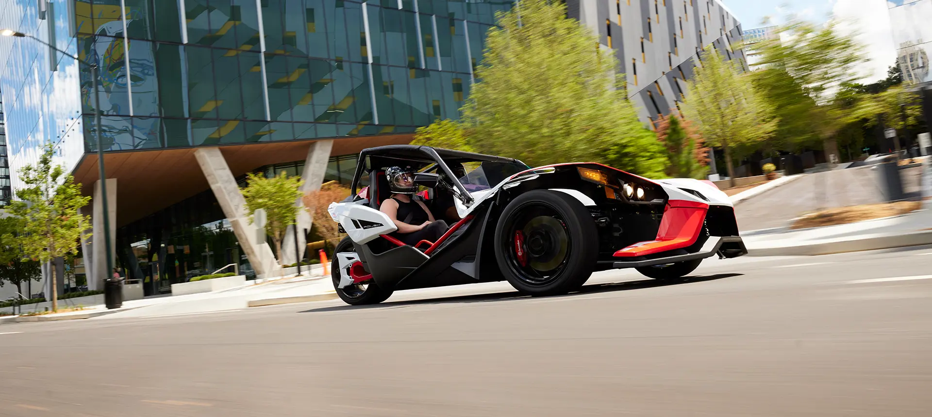 people watching the sunset near their 2024 polaris slingshot ROUSH® edition roadster