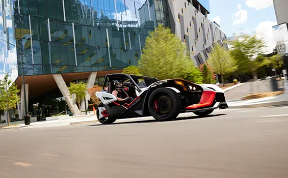 people watching the sunset near their 2024 polaris slingshot ROUSH® edition roadster