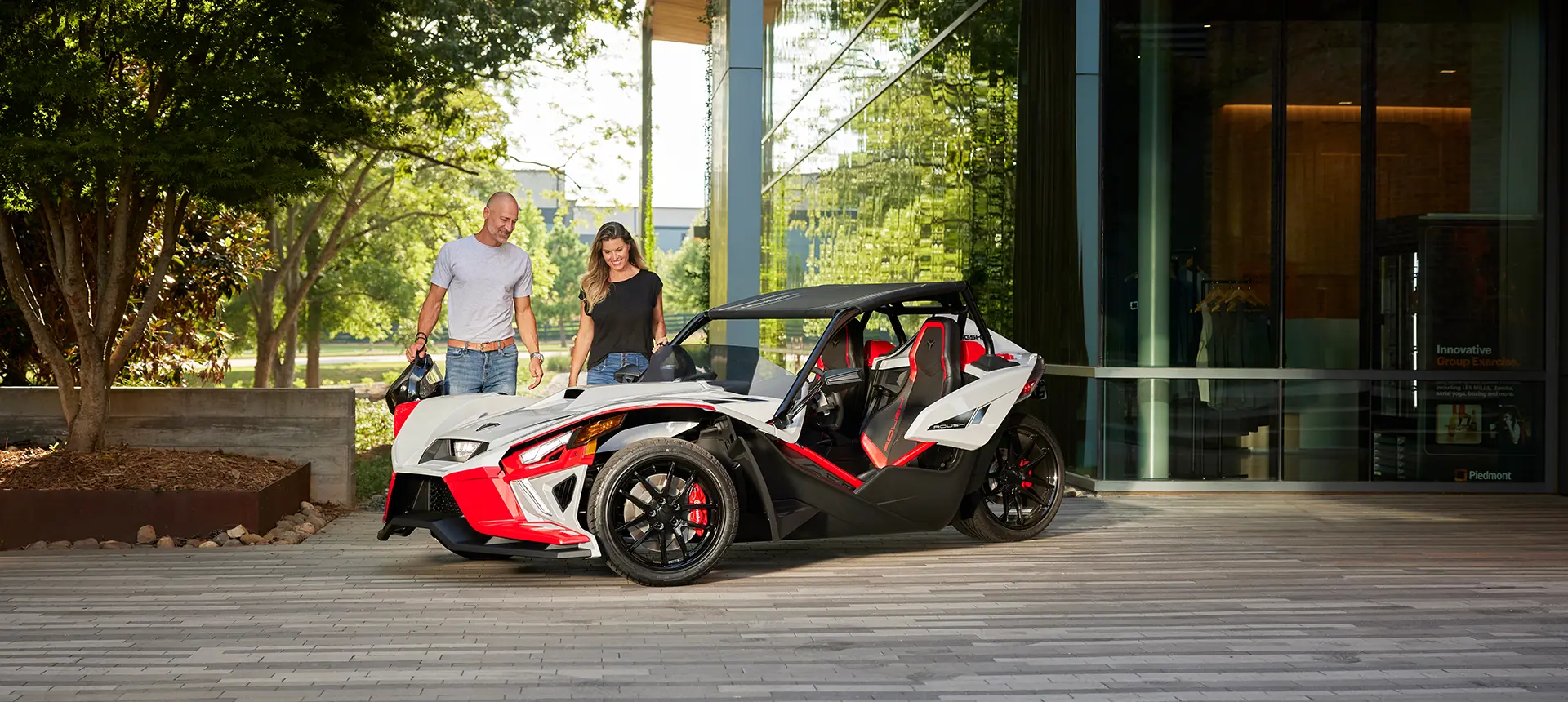 couple walking towards a Slingshot ROUSH® Edition