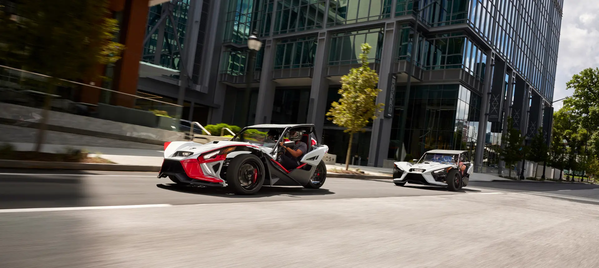 2 slingshots on a city street