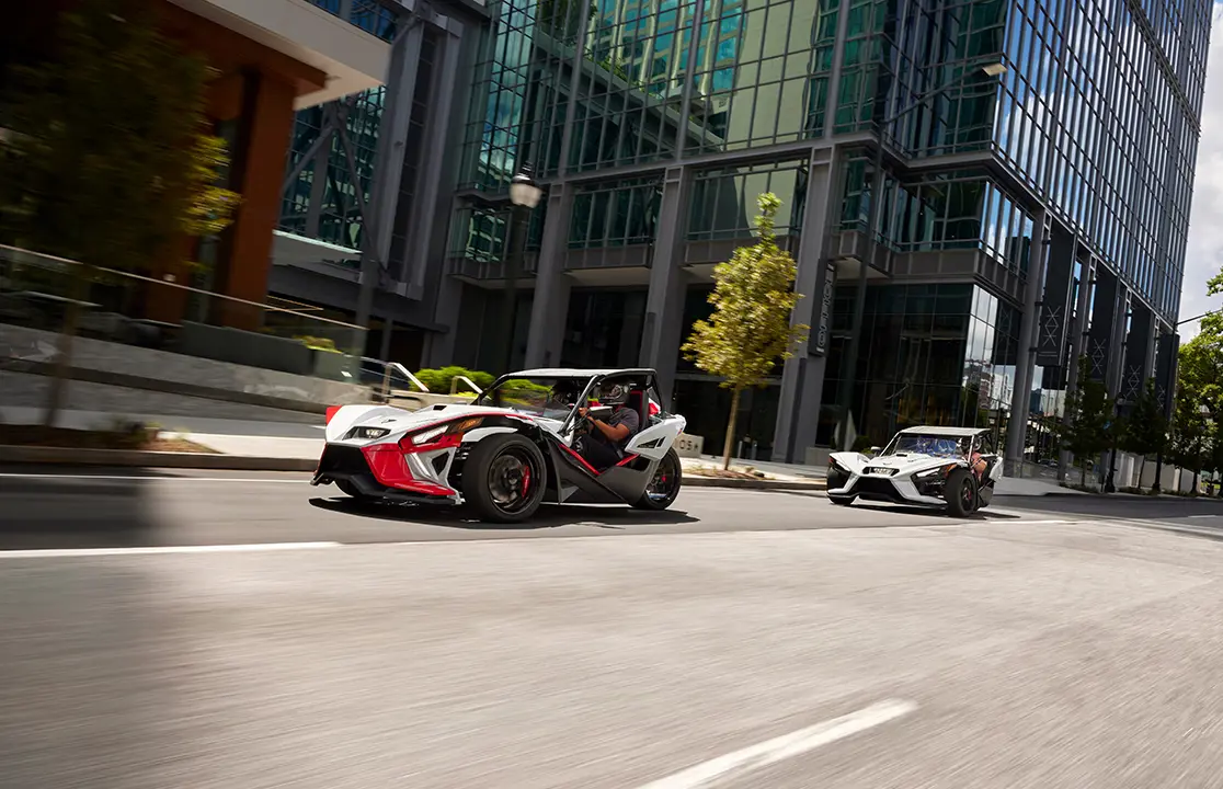 2 slingshots on a city street
