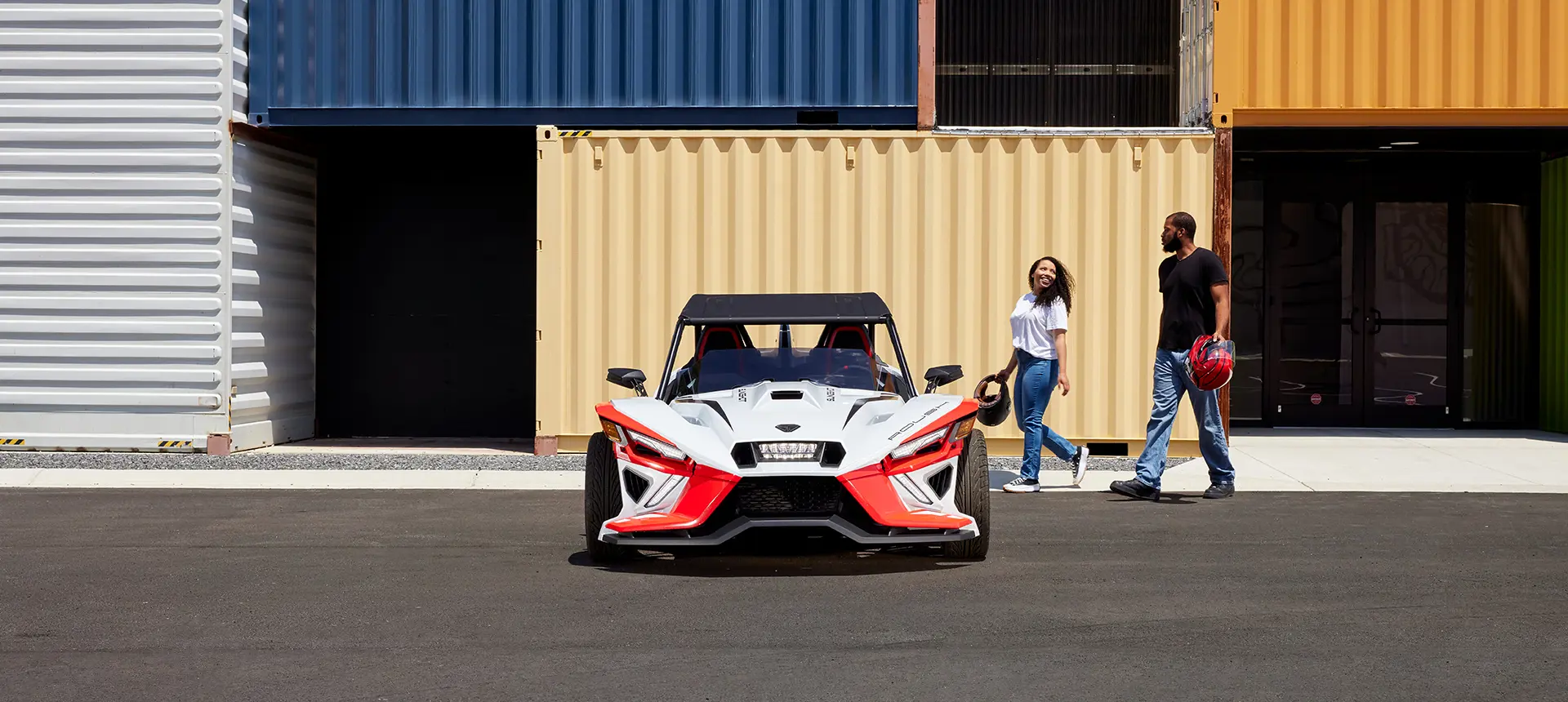 front view of a couple walkign towards a Slingshot ROUSH® Edition