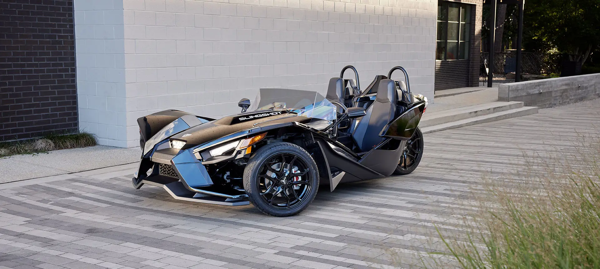 side profile of a jet black polaris slingshot s three-wheeled motorcycle