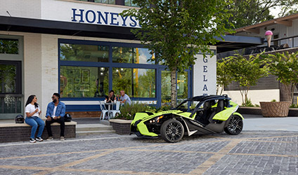 A Polaris Slingshot vehicle parked in a commercial area