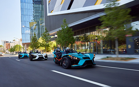 Three Polaris Slingshot riding in the city street