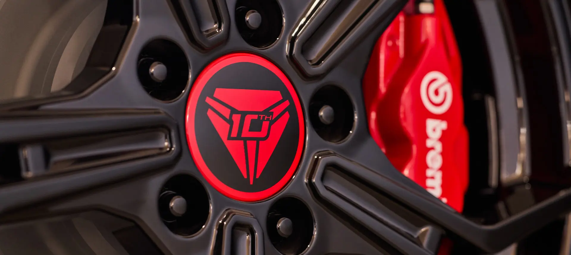 Deux personnes tenant un casque et marchant vers un cabriolet stationné Polaris Slingshot 2025 10 à trois roues, édition 10e anniversaire.