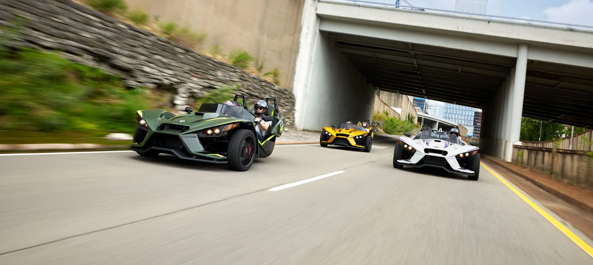 three 2024 slingshot r three-wheeled motorcycles cruising