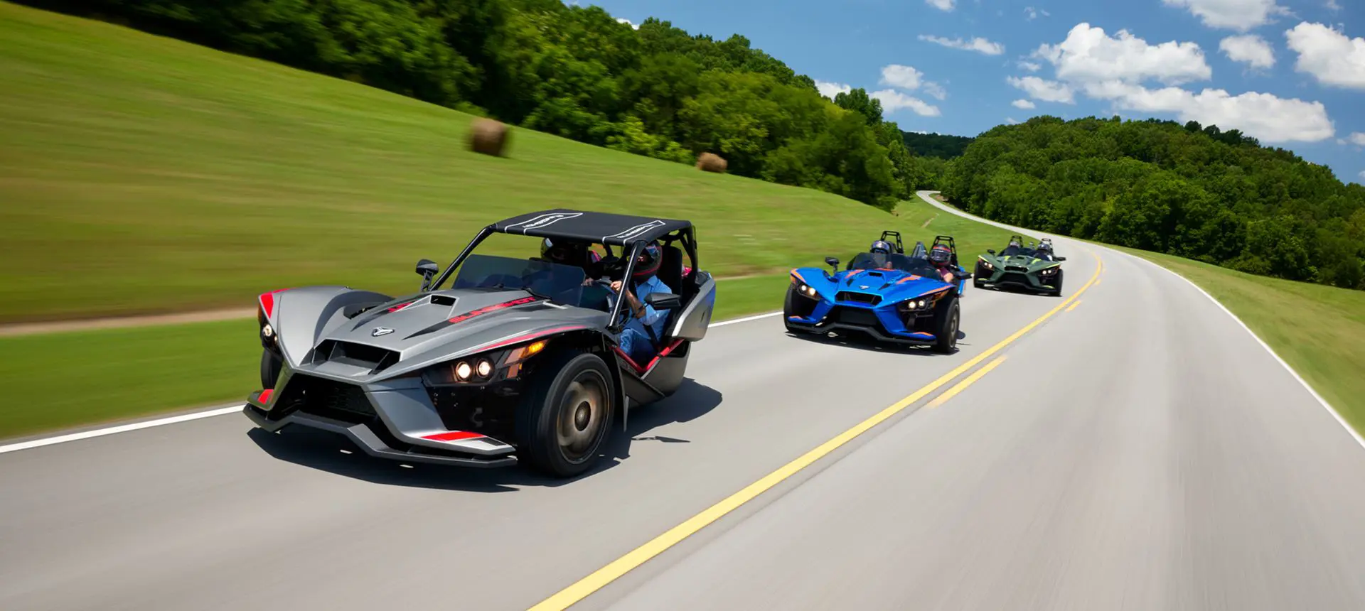 three 2024 slingshot r three-wheeled motorcycle cruising on a country road