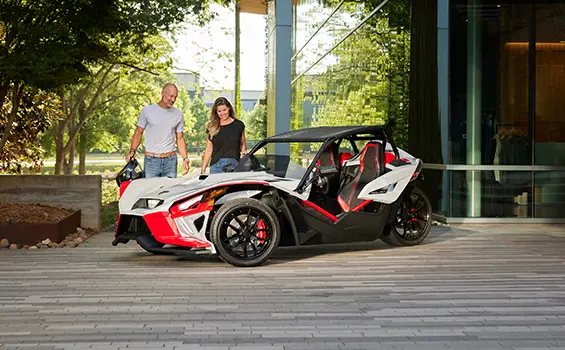 people walking towards a 2024 polaris slingshot ROUSH® edition roadster
