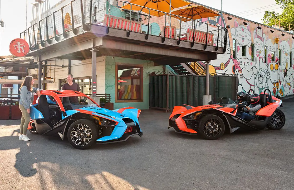 people meeting up in their polaris slingshot SL three-wheeled motorcycles