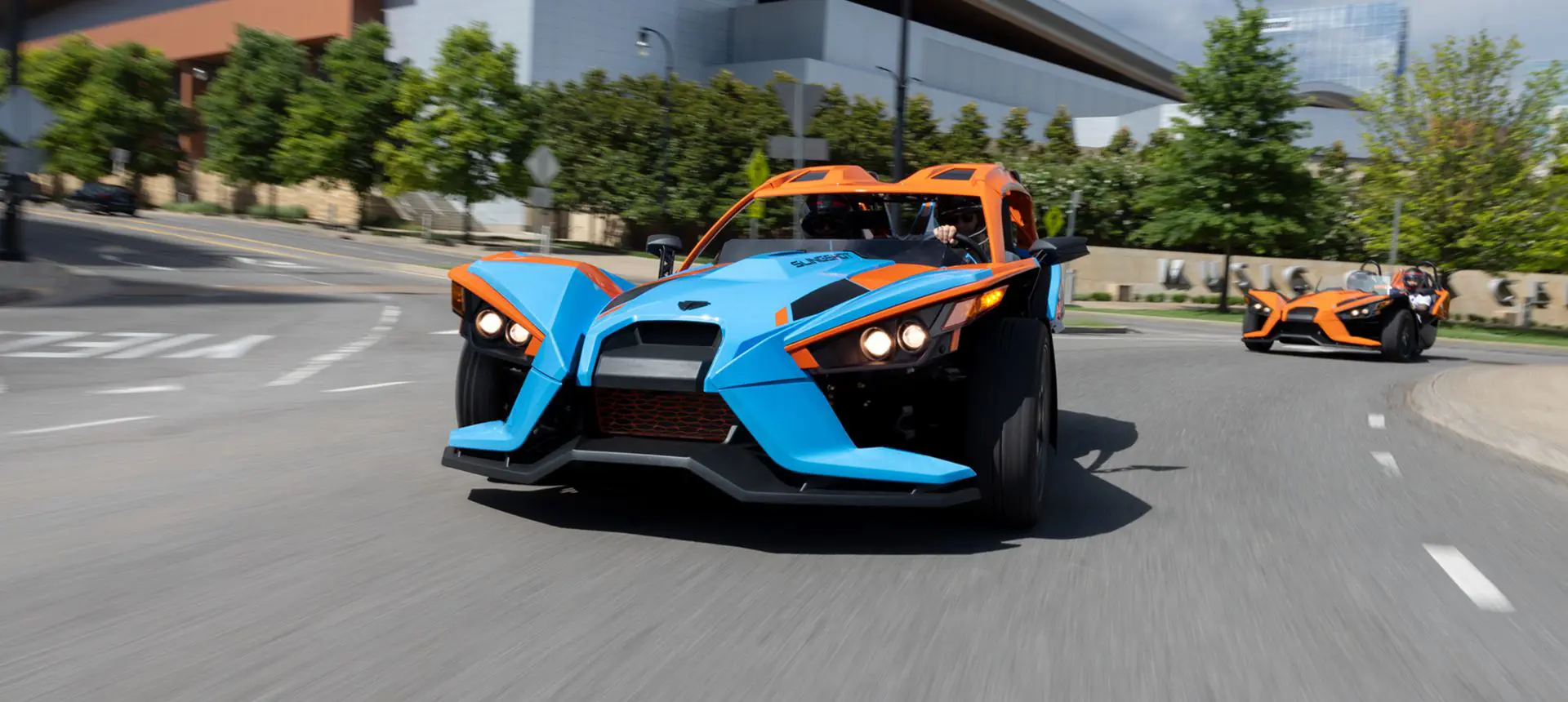 two polaris slingshot sl three-wheeled motorcycles on the highway