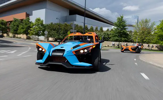 two polaris slingshot sl three-wheeled motorcycles on the highway