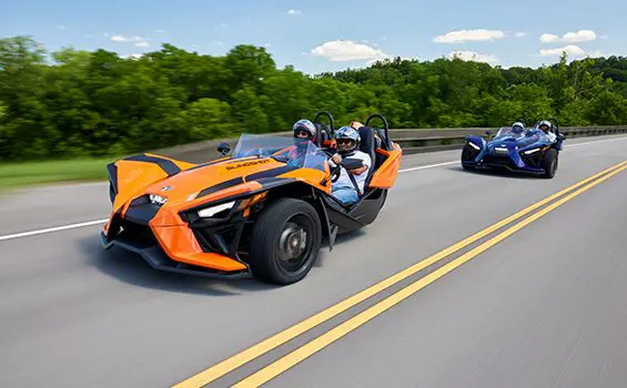two polaris slingshot sl three-wheeled motorcycles on the highway