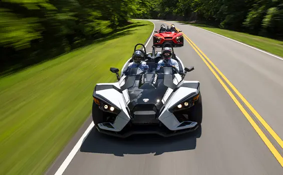 aerial view of 2 2024 polaris slingshot slr three-wheeled motorcycles on a highway