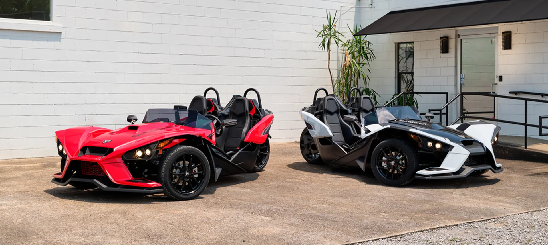 two 2024 polaris slingshot slr three-wheeled motorcycles parked