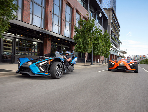 Two Slingshots on a city street.