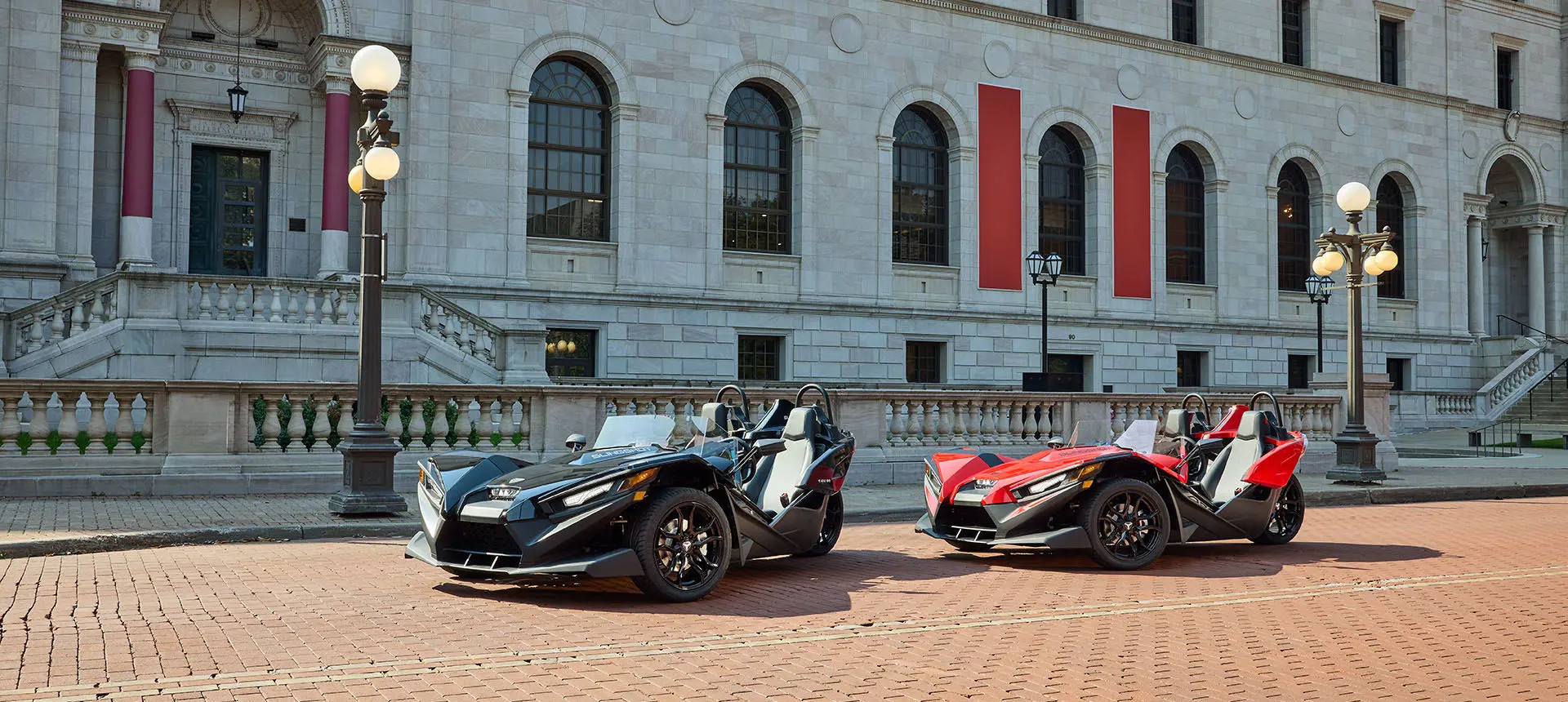Two 2026 Polaris Slingshot S three-wheeled motorcycles parked.