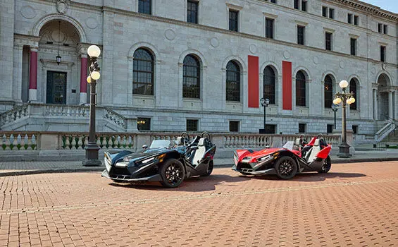 Two 2026 Polaris Slingshot S three-wheeled motorcycles parked.