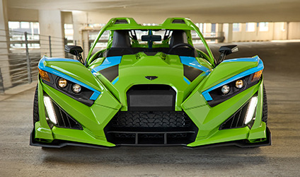 A Polaris Slingshot vehicle parked in a commercial area