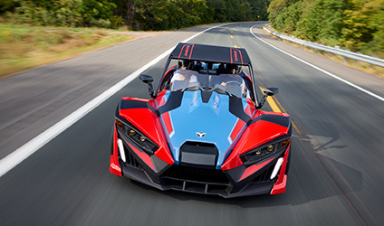 A Polaris Slingshot vehicle parked in a commercial area