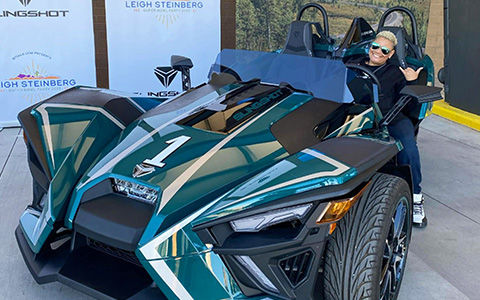 Porsche Taylor, founder of Black Girls Ride, smiling in Polaris Slingshot vehicle.