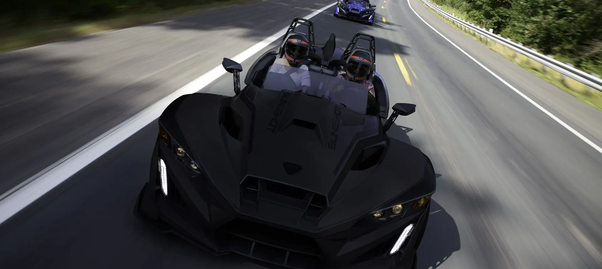 A 2026 Slingshot R three-wheel roadster cruising down the highway.