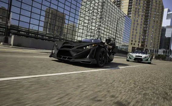 2 2026 Slingshot R three-wheel motorcycles cruising through a city.