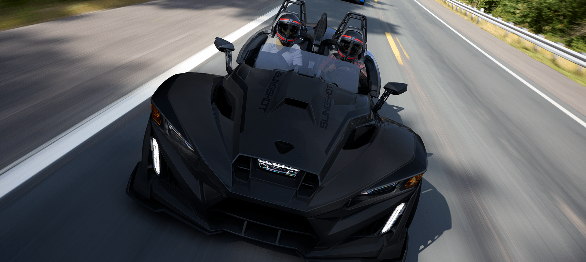 A 2026 Slingshot R three-wheel roadster cruising down the highway.
