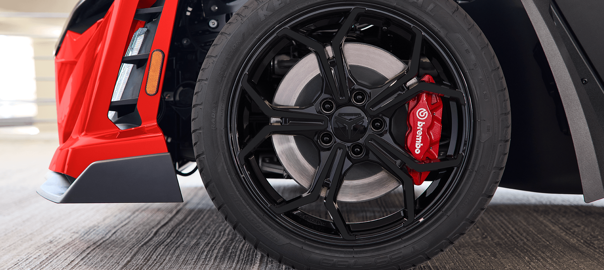Closeup of the Brembo brakes and wheels on a 2026 Polaris Slingshot R three-wheel roadster.