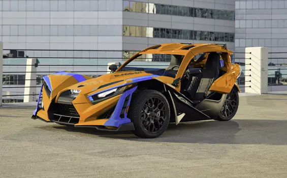 A 2026 Polaris Slingshot SL three-wheel motorcycle parked in a city.