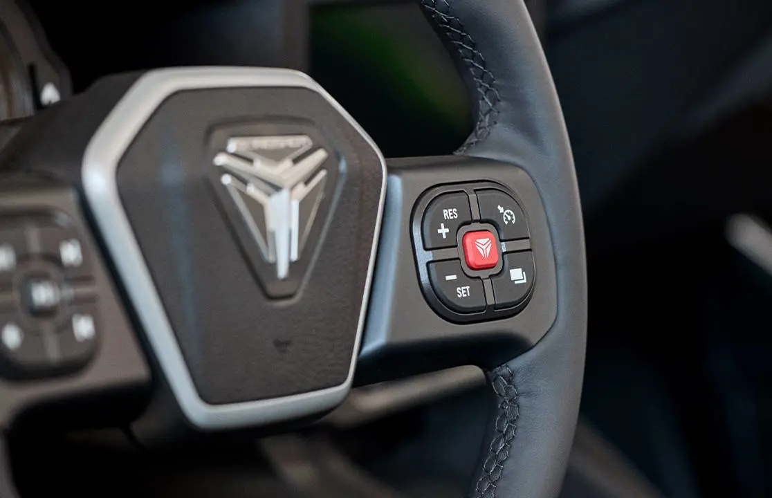 Closeup of the steering wheel and buttons in a 2026 Polaris Slingshot SL three-wheel roadster.