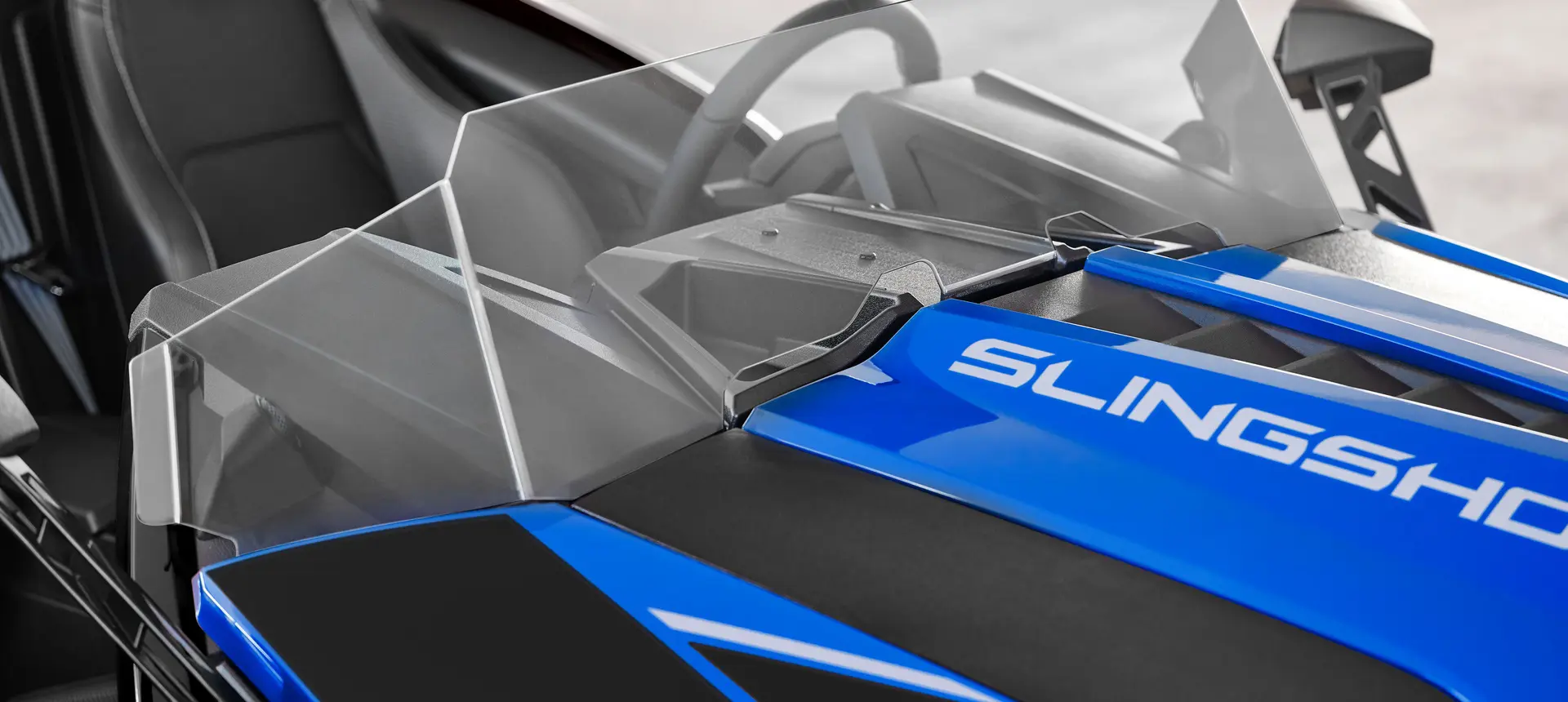 Closeup of the windshield on a 2026 Polaris Slingshot SLR three-wheel roadster.