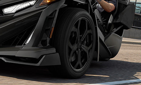Close-up of the 5-spoke honeycomb wheel design on a 2026 Polaris Slingshot R three-wheel motorcycle.
