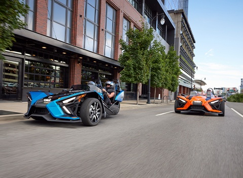 Two Slingshots on a city street. 