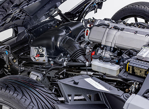 Close-up of a Polaris Slingshot engine bay showing the intake, alternator, hoses and electrical components.