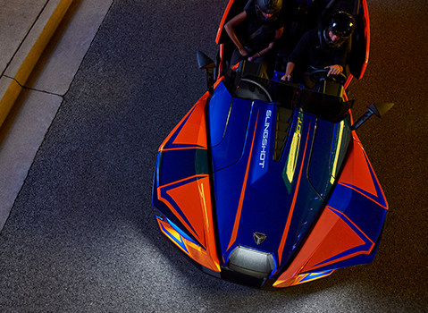 Overhead view of a couple riding a Slingshot R at night
